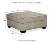 Ashley Furniture Bovarian Ottoman with plush fabric upholstery and wooden legs, showcasing a stylish and functional living room accent piece.