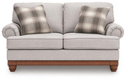 Ashley Furniture Clearbrooke living room set featuring a sofa and loveseat with light beige upholstery and plush cushions.