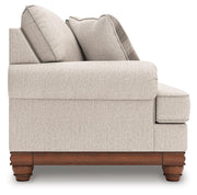 Ashley Furniture Clearbrooke living room set featuring a sofa and loveseat with beige upholstery and plush cushions.