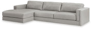 Ashley Furniture Amiata sectional with chaise showing beige upholstered fabric and modern design from an angled view.