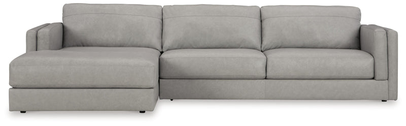 Ashley Furniture Amiata sectional with chaise, showing plush upholstered sofa with chaise lounge, in a modern living room setting.