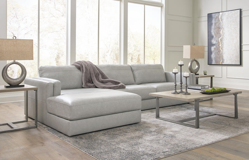Ashley Furniture Amiata sectional with chaise, featuring plush cushions and a modern design in a neutral fabric.