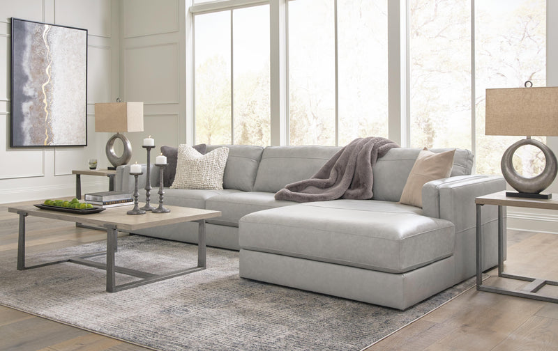 Ashley Furniture Amiata sectional with chaise, featuring plush pillows and modern design, in a cozy living room setting.