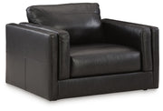 A large Ashley Furniture Amiata oversized chair with plush fabric and wide armrests, shown from an angled side view.