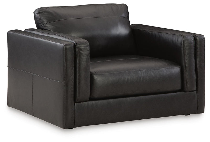 A large Ashley Furniture Amiata oversized chair with plush fabric and wide armrests, shown from an angled side view.