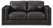 Ashley Furniture Amiata upholstery package for living room set, showing plush sofa with beige fabric and decorative cushions.