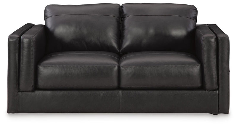 Ashley Furniture Amiata upholstery package for living room set, showing plush sofa with beige fabric and decorative cushions.