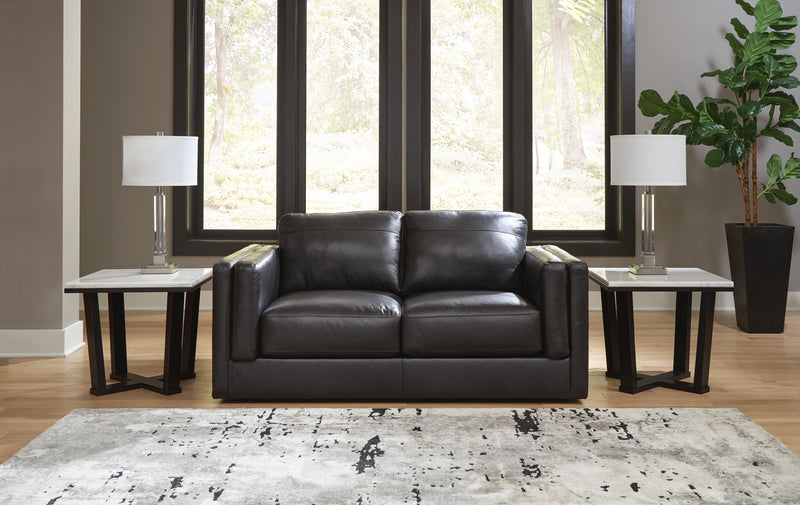 Amiata loveseat by Ashley Furniture featuring plush fabric and cozy cushioning in a modern living room setting.