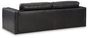 Ashley Furniture Amiata upholstery package for living room set, showing fabric-covered sofa back and cushions in neutral tones.