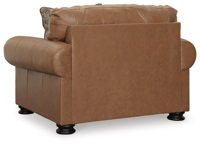 Ashley Furniture Carianna oversized chair with plush fabric and wide armrests, shown from the back in a cozy living room setting.