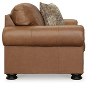 Ashley Furniture Carianna oversized chair with plush fabric and wide armrests, shown from the side in a modern living room setting.
