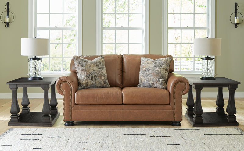 Ashley Furniture Carianna loveseat with plush fabric and wide armrests, shown in a cozy living room setting.
