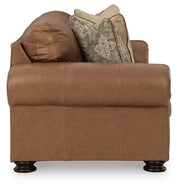 Ashley Furniture Carianna sofa with plush fabric and stylish side cushions, shown from a side angle in a modern living room setting.