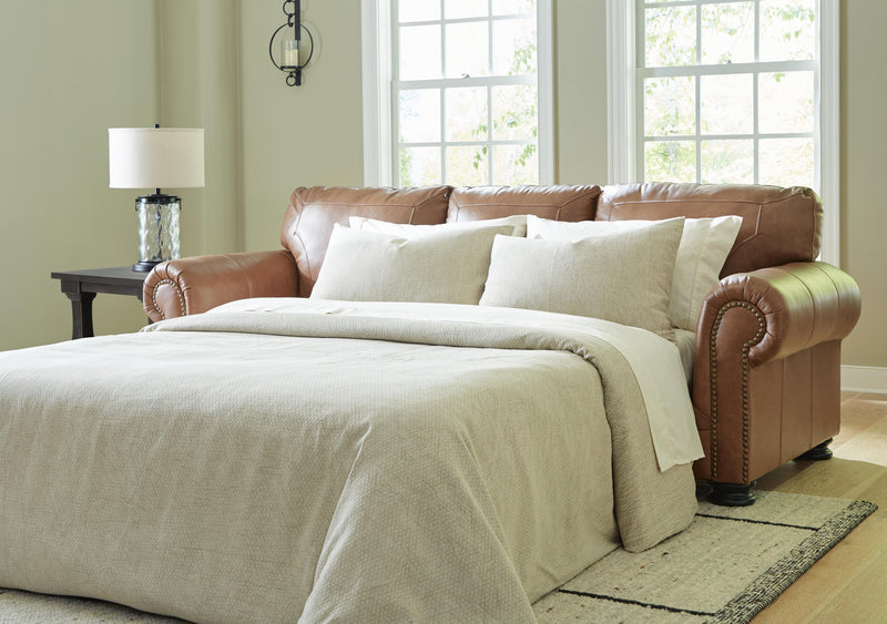 Ashley Furniture Carianna Sofa Sleeper with plush upholstery and convertible design, perfect for comfortable seating and sleeping.