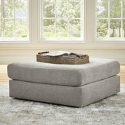 Ashley Furniture Avaliyah oversized accent ottoman with cushioned top and wooden legs, stylishly designed for living room decor.