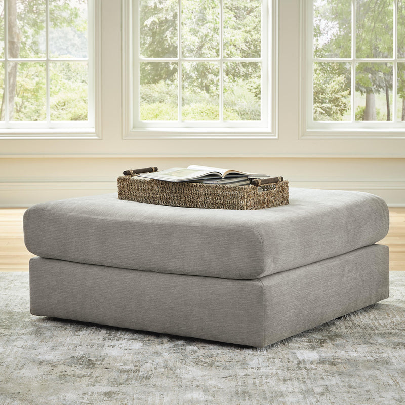 Ashley Furniture Avaliyah oversized accent ottoman with cushioned top and wooden legs, stylishly designed for living room decor.