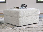 Ashley Furniture Cuddle Plush Sectional in soft, plush fabric with wide armrests and deep seating for comfortable lounging.