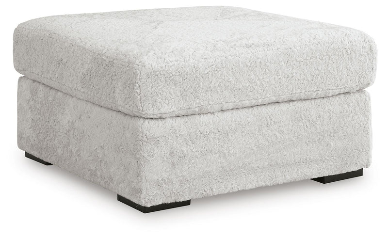 Ashley Furniture Cuddle Plush Sectional sofa with soft plush fabric, angled view showing spacious seating and plush cushions.