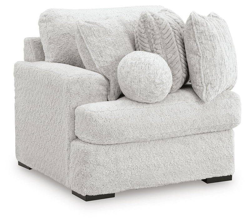 Ashley Furniture Cuddle Plush Sectional with Chaise shown from an angled view, featuring plush upholstery and a spacious chaise lounge.