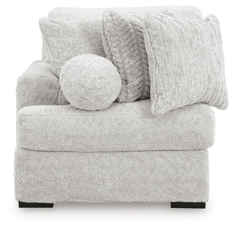 Ashley Furniture Cuddle Plush sectional with chaise, featuring soft fabric and plush cushions for a cozy seating area.
