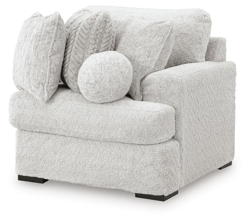 Ashley Furniture Cuddle Plush sectional with chaise, featuring soft upholstery and modern design, viewed from an angled side.