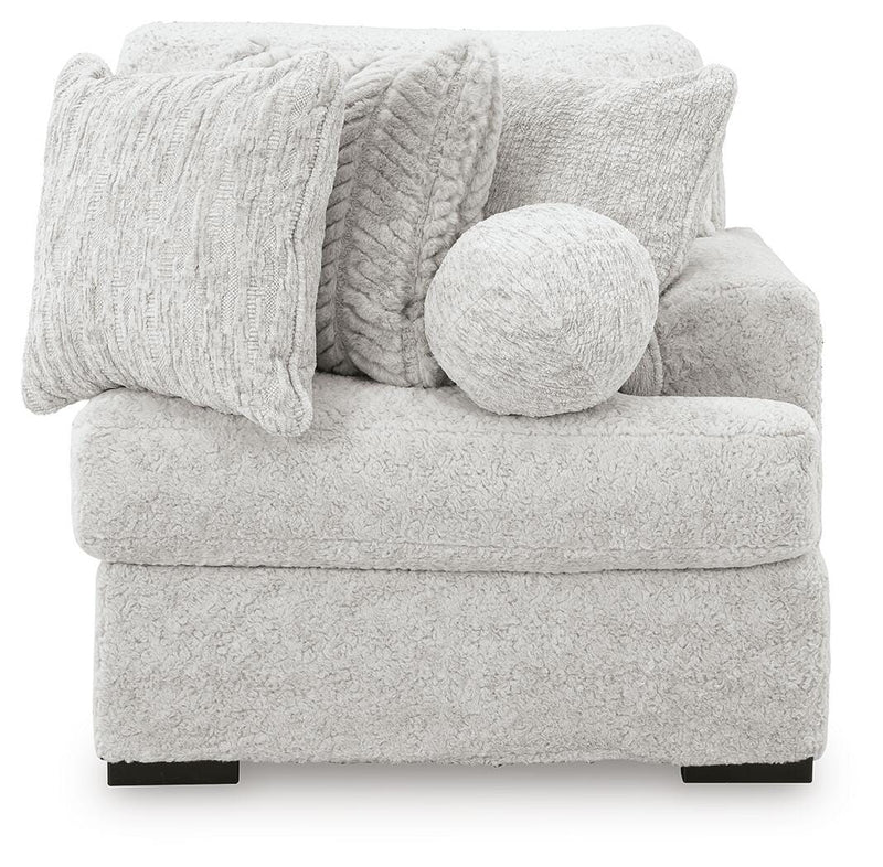 Ashley Furniture Cuddle Plush Sectional with Chaise, featuring soft plush upholstery and a spacious chaise lounge.