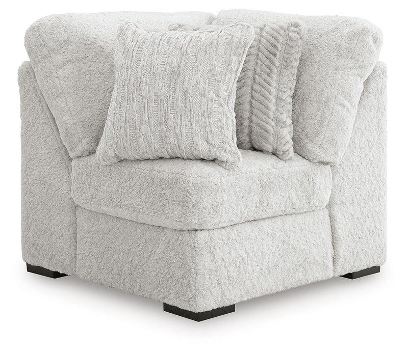 Ashley Furniture Cuddle Plush sectional with chaise, featuring soft fabric upholstery and plush cushions in a cozy living room setting.
