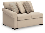 Ashley Furniture LadyMae sectional with chaise, tan fabric, angled view showing plush cushions and modern living room style.