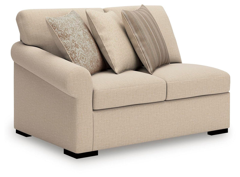 Ashley Furniture LadyMae sectional with chaise, tan fabric, angled view showing plush cushions and modern living room style.