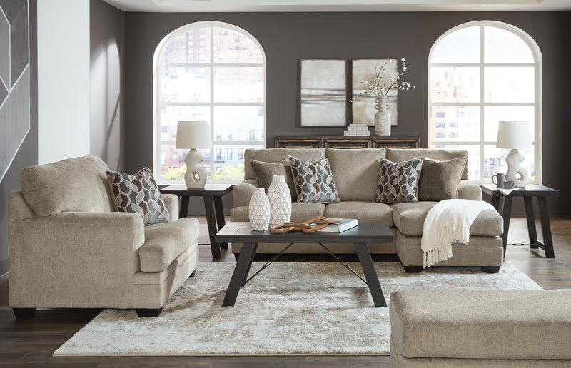 Ashley Furniture Stonemeade living room set with sofa, loveseat, and armchair in neutral fabric, arranged in a cozy seating area.