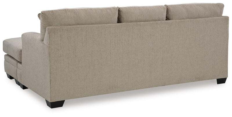 Ashley Furniture Stonemeade living room set with sofa and armchair, featuring neutral upholstery and wooden legs.