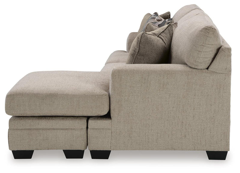 Ashley Furniture Stonemeade living room set with a sofa and matching armchair in neutral upholstery and wooden accents.