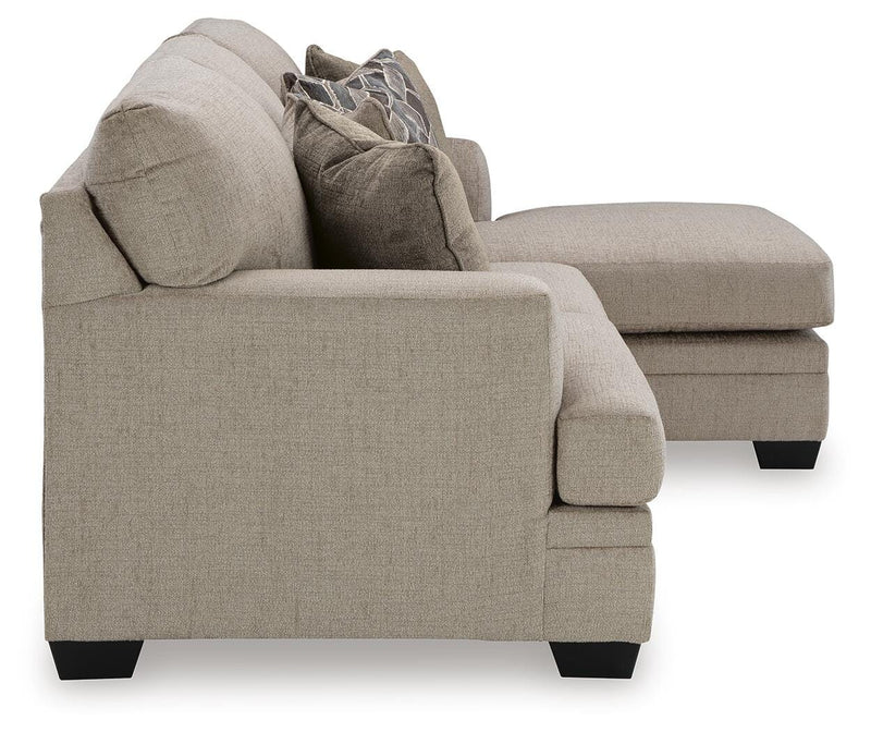 Ashley Furniture Stonemeade living room set with sofa and armchair featuring neutral upholstery and wooden accents.