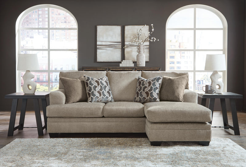 Ashley Furniture Stonemeade living room set with sofa and armchair featuring beige upholstery and wooden accents.