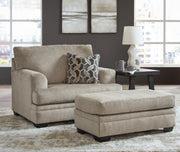 Ashley Furniture Stonemeade living room set with sofa and armchair, featuring neutral upholstery and wooden accents.