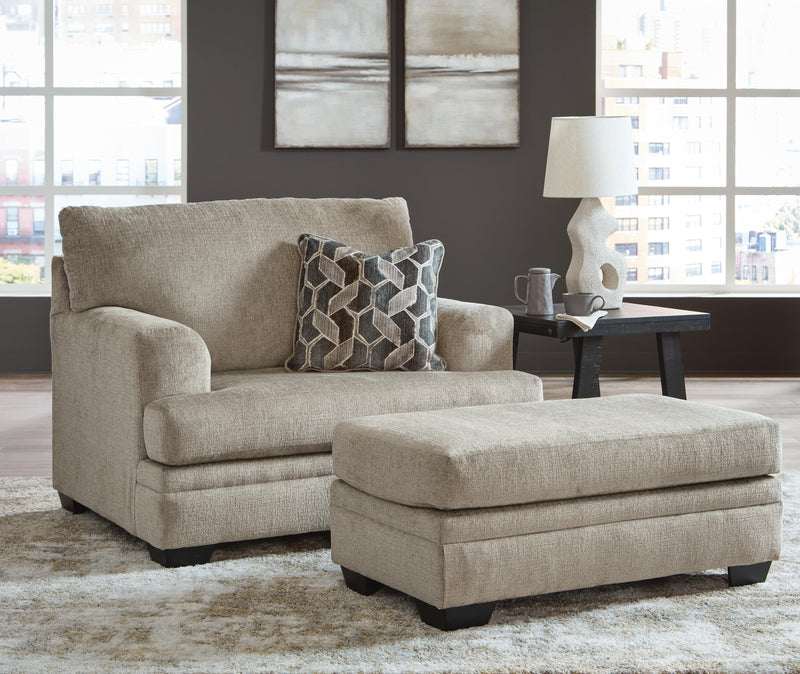 Ashley Furniture Stonemeade living room set with sofa and armchair, featuring neutral upholstery and wooden accents.