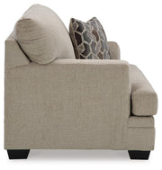 Ashley Furniture Stonemeade living room set with sofa and armchair, featuring neutral upholstery and wooden legs.