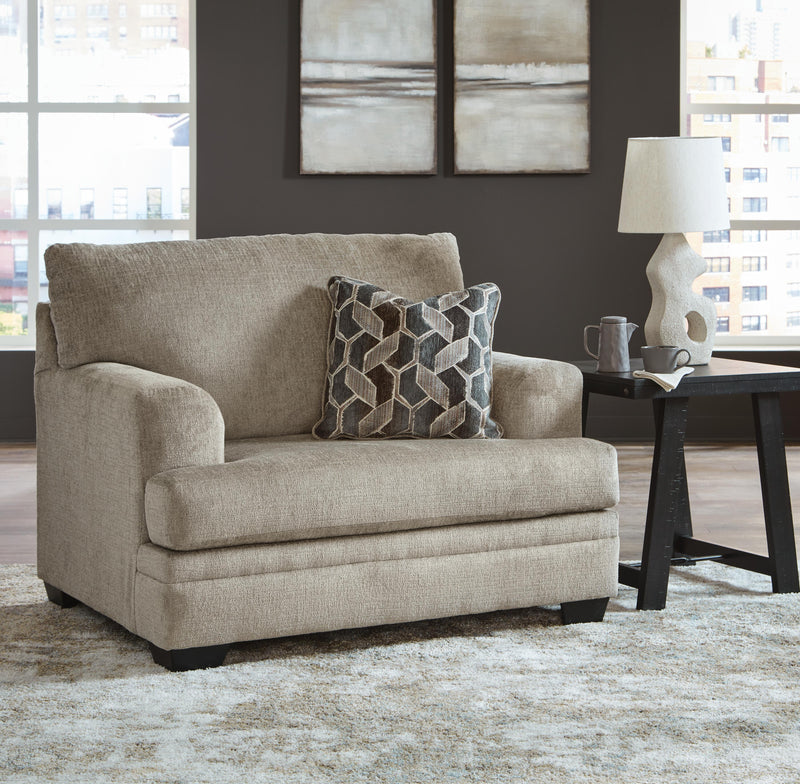 Ashley Furniture Stonemeade living room set with sofa, loveseat, and armchair in neutral upholstery, arranged in a cozy living space.