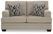 Ashley Furniture Stonemeade living room set with sofa and armchair, featuring neutral upholstery and wooden legs.