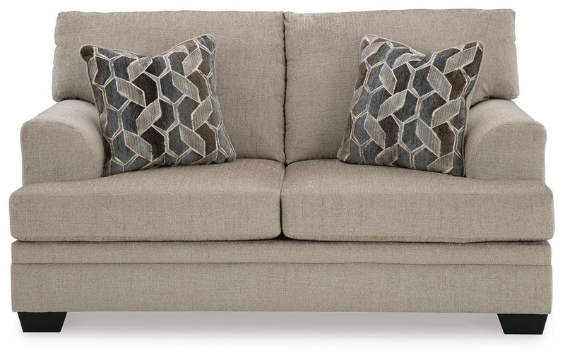 Ashley Furniture Stonemeade living room set with sofa and armchair, featuring neutral upholstery and wooden legs.