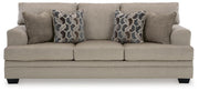 Ashley Furniture Stonemeade living room set featuring a sofa and loveseat with neutral fabric and decorative cushions.