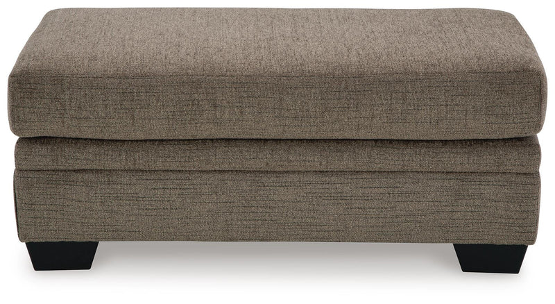 Ashley Furniture Stonemeade living room set with sofa and armchair, featuring neutral fabric upholstery and wooden legs.