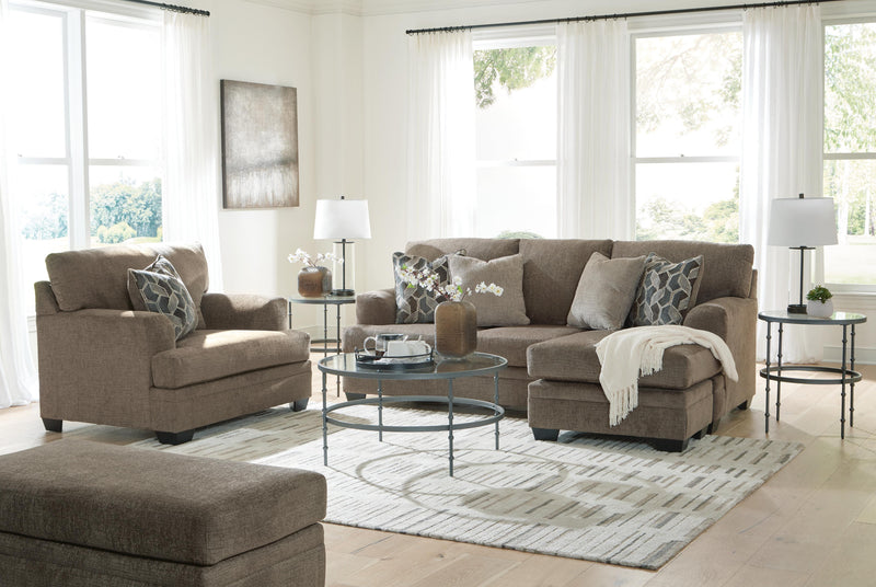 Ashley Furniture Stonemeade living room set with plush sofa, armchair, and coordinating ottomans in a modern fabric design.