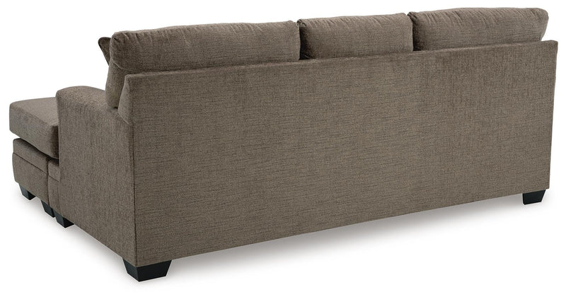 Ashley Furniture Stonemeade living room set with a sofa and armchair featuring neutral upholstery and wooden accents.