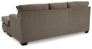 Ashley Furniture Stonemeade sofa chofa with chaise, featuring plush cushions and dark wood legs, shown from the back angle.