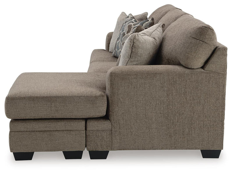 Ashley Furniture Stonemeade sofa chaise in beige fabric, showing the side view with plush cushions and a modern design.