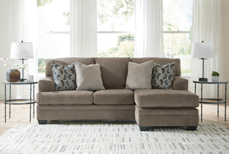 Ashley Furniture Stonemeade living room set with sofa, loveseat, and armchair in a neutral fabric, arranged in a cozy living space.