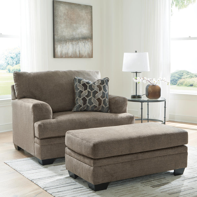 Ashley Furniture Stonemeade living room set with sofa and armchair, featuring neutral fabric and wooden accents in a modern design.