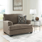 Ashley Furniture Stonemeade living room set with plush sofa and armchairs, featuring neutral fabric and wooden legs.