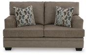 Ashley Furniture Stonemeade living room set showing a beige sofa, loveseat, and armchair with plush cushions and wooden legs.